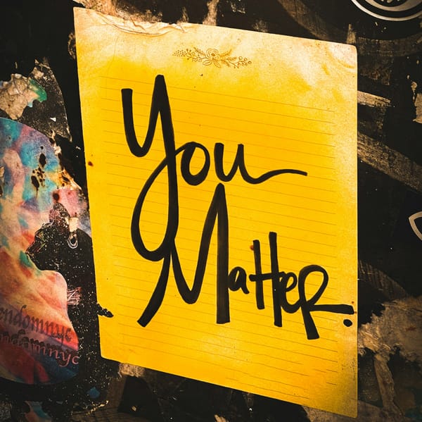 a yellow sign with the words "You Matter." written in black marker